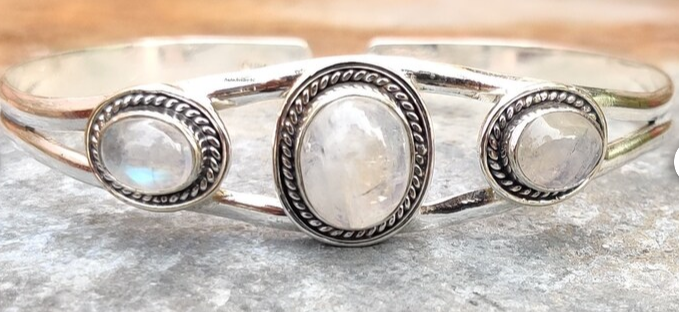 sterling silver bangle bracelet with three moonstone gemstones.